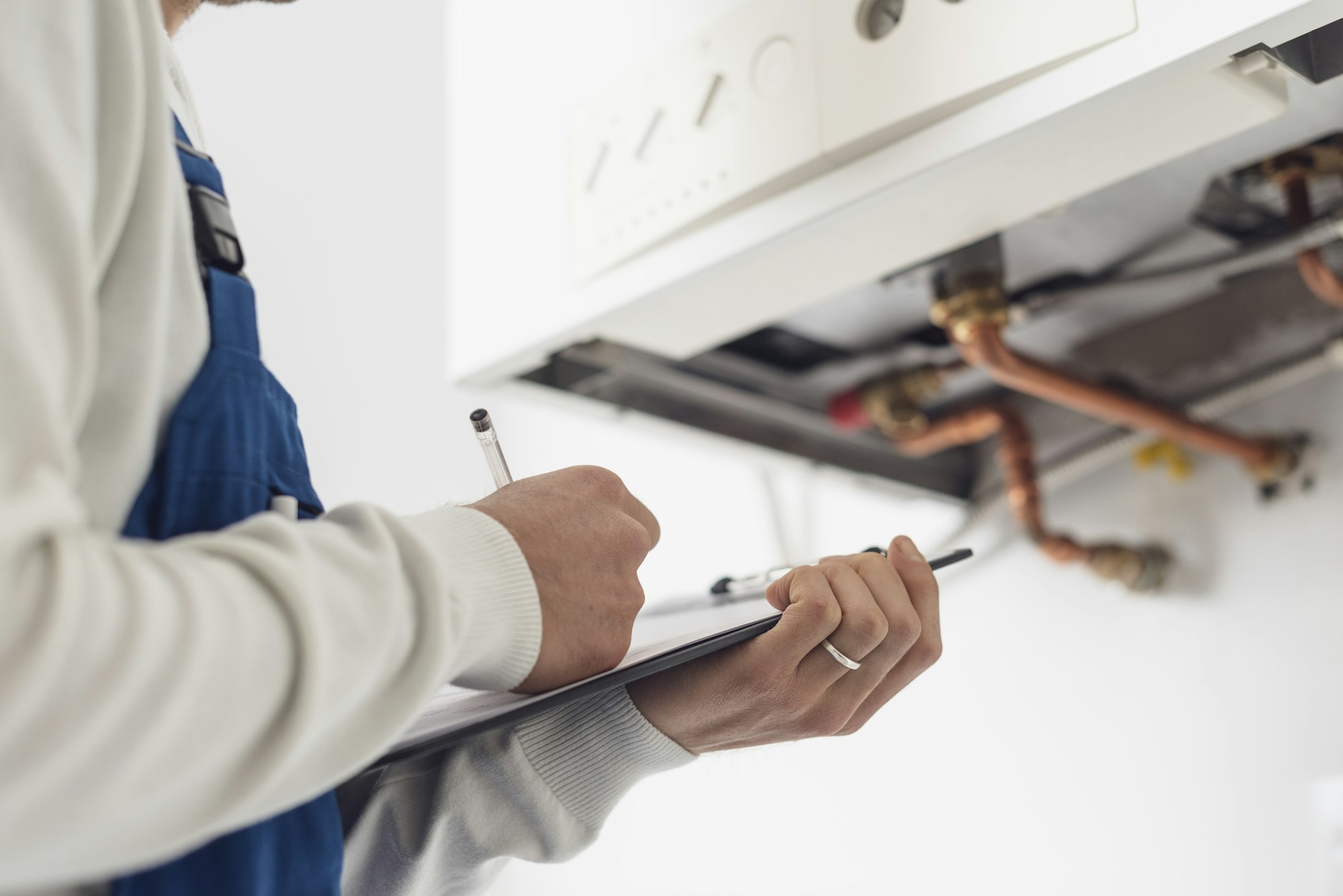 Professional plumber doing a boiler check